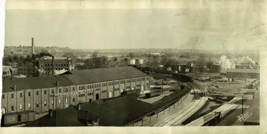 Railroads via Valentine Museum - Black and white photograph of the exterior of the Standard Paper Manufacturing Company and Southern Railway Depot on East 1st and Hull Streets. (Stead Studio, 1925)