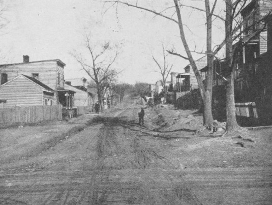 "Ramshackle Negro houses, muddy street, no sidewalks, in Fulton."  via